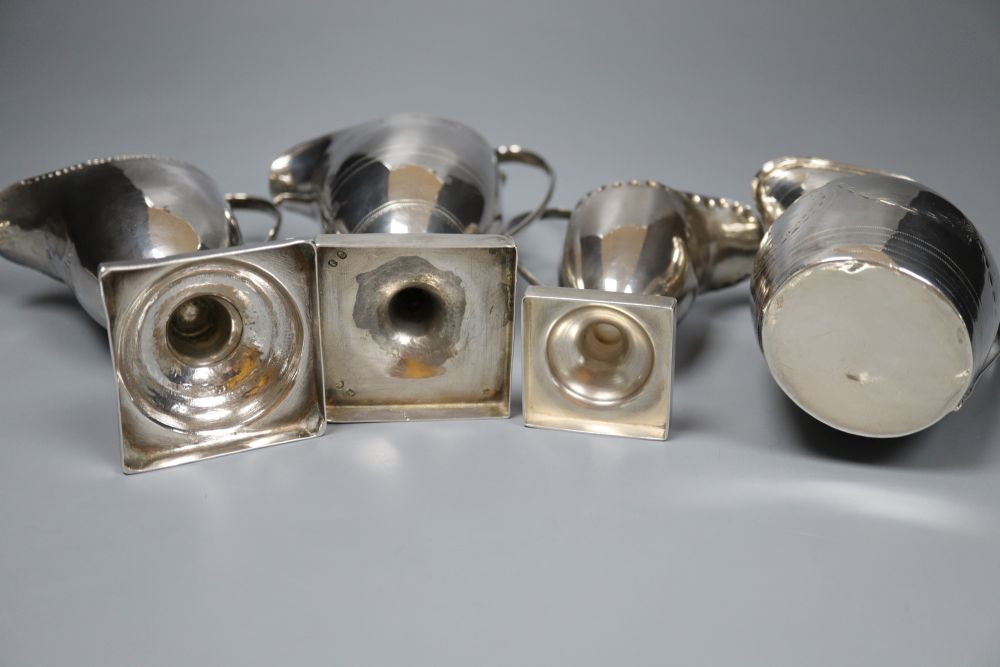 Four silver helmet-shaped cream jugs, approx 11oz